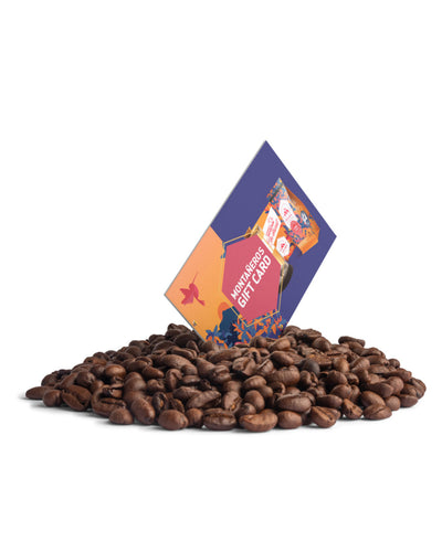 Gift card on a pile of coffee beans with a white background
